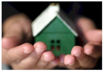 Hands holding a house